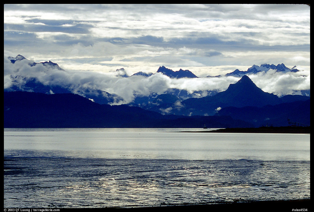 Low clouds haning over Kenai Mountains across Katchemak Bay. Homer, Kenai Peninsula, Alaska, USA