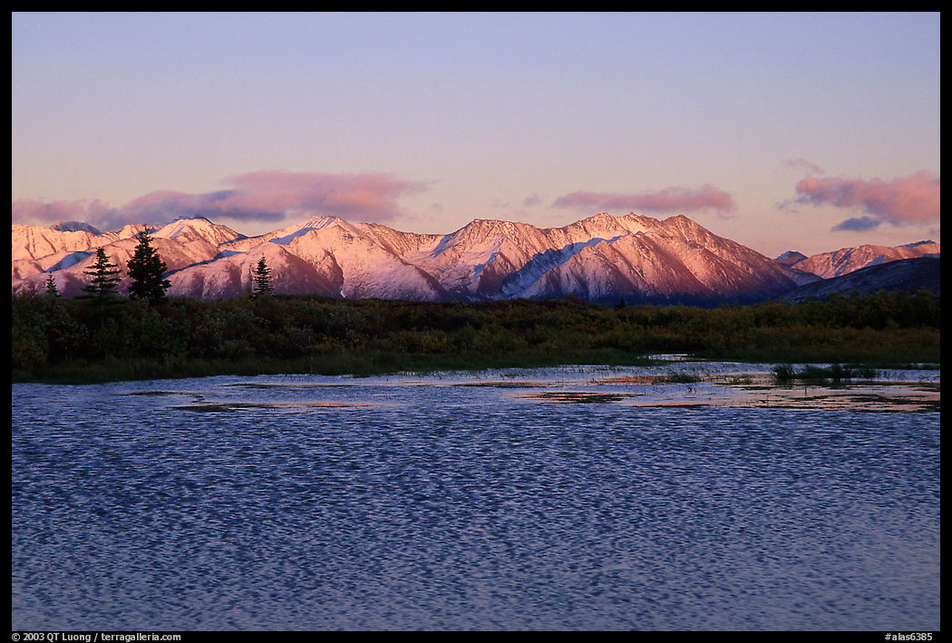 Lake with water ripples and mountains at sunset. Denali Highway, Central Alaska, USA