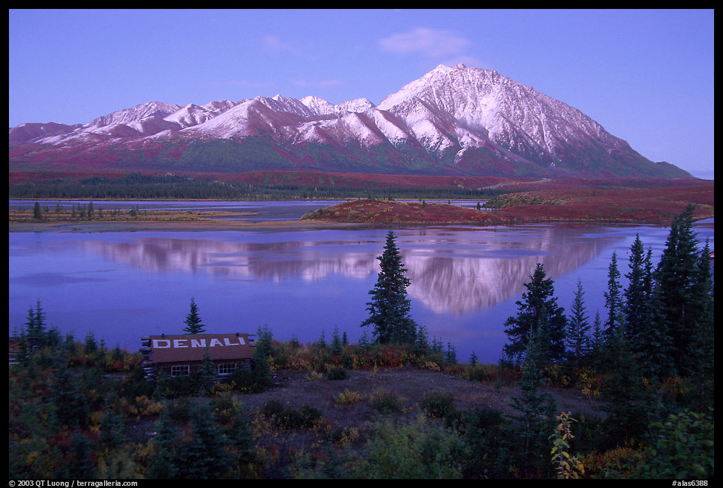 Mountains and lake at dusk, cabin with Denali sign. Denali Highway, Central Alaska, USA