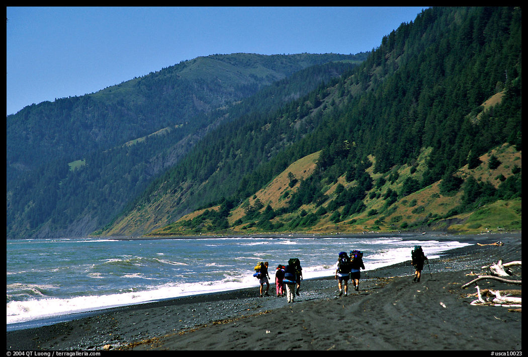 Backpackers on black sand beach and King Range, Lost Coast. California, USA