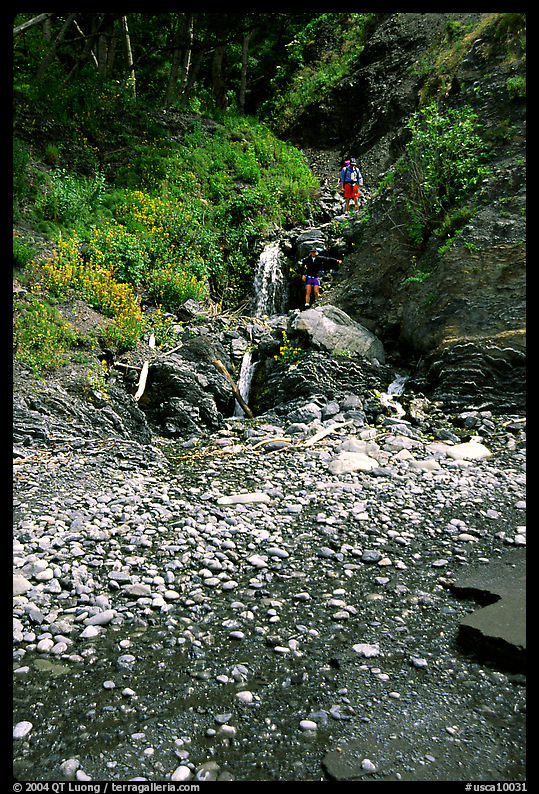Hikers exploring a cascade, Lost Coast. California, USA