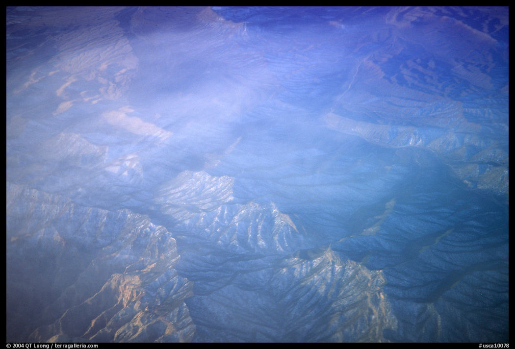 Aerial view of desert mountains with thin clouds. California, USA