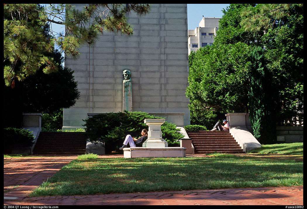 Reading at the base of the Campanile on the UC Campus, Berkeley. Berkeley, California, USA