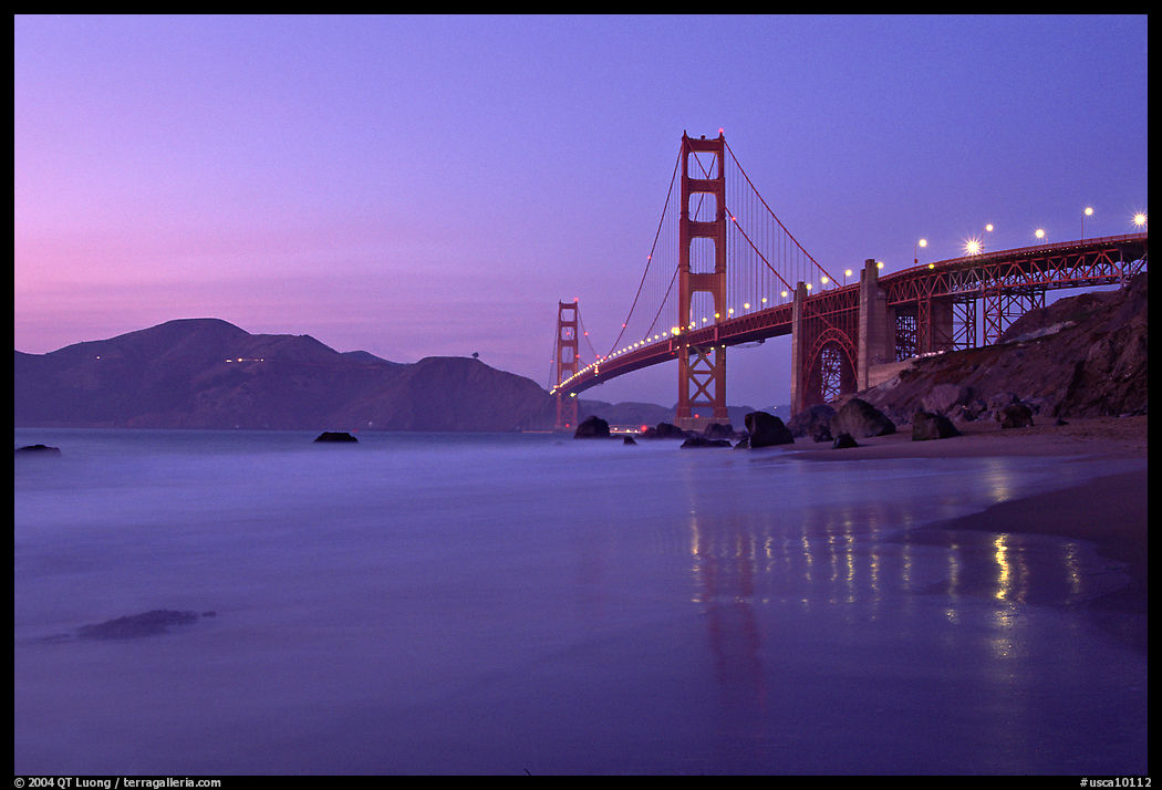 Golden Gage bridge at dusk, reflected in wet sand at East Baker Beach. San Francisco, California, USA