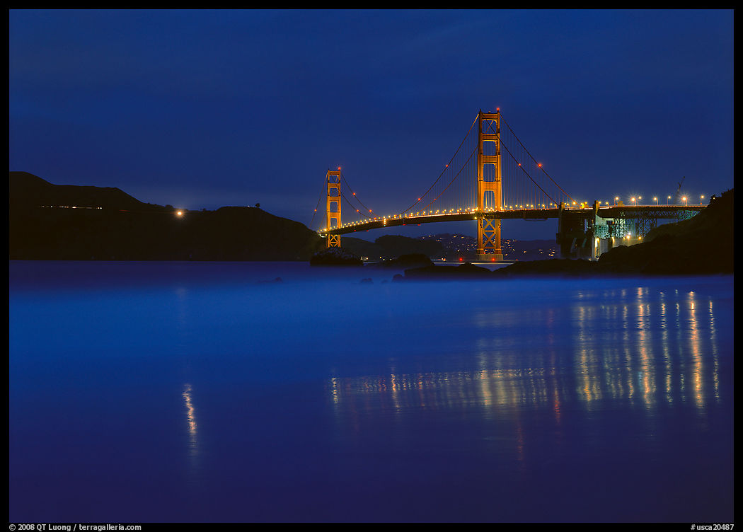 Golden Gate Bridge reflected in wet sand, blue hour. San Francisco, California, USA