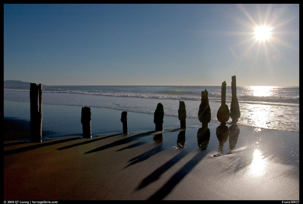 Row of wood pilars and sun near Fort Funston,  late afternoon, San Francisco. San Francisco, California, USA