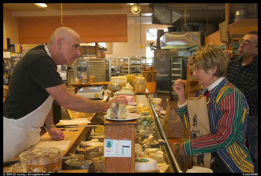 Choosing cheese at the Cheese Board, Berkeley. Berkeley, California, USA