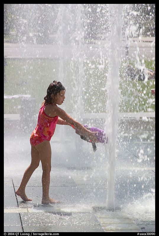 Girl refreshing herself, Cesar de Chavez Park. San Jose, California, USA