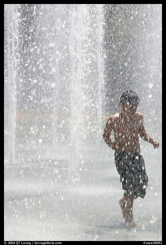 Boy refreshing himself  Cesar de Chavez Park. San Jose, California, USA