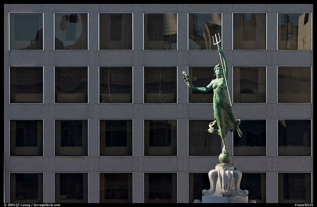 Statue on Admiral Dewey memorial column in front of modern building. San Francisco, California, USA