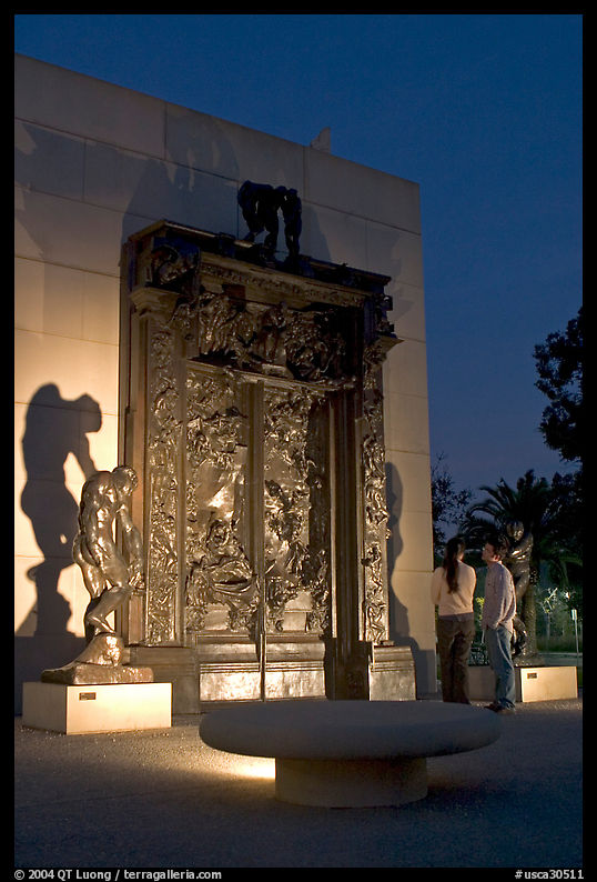 A couple contemplates Rodin's Gates of Hell at night. Stanford University, SF Bay area, California, USA