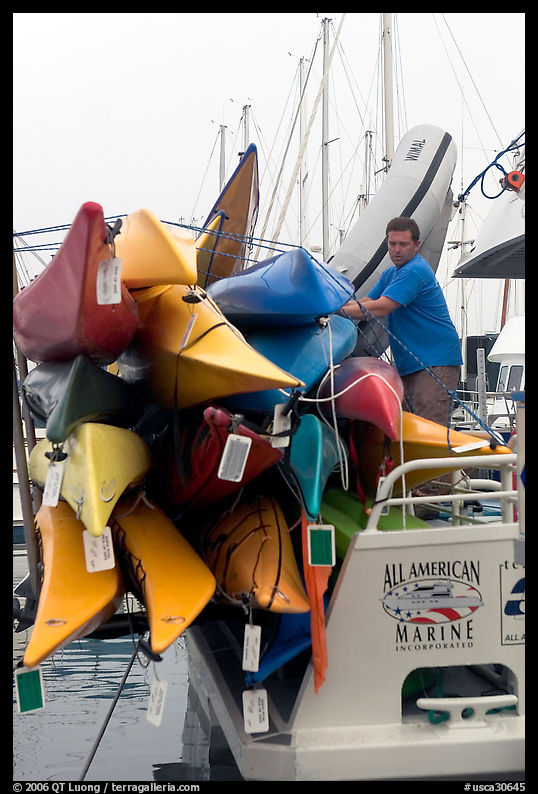 Sea Kayaks attached to a tour boat. California, USA