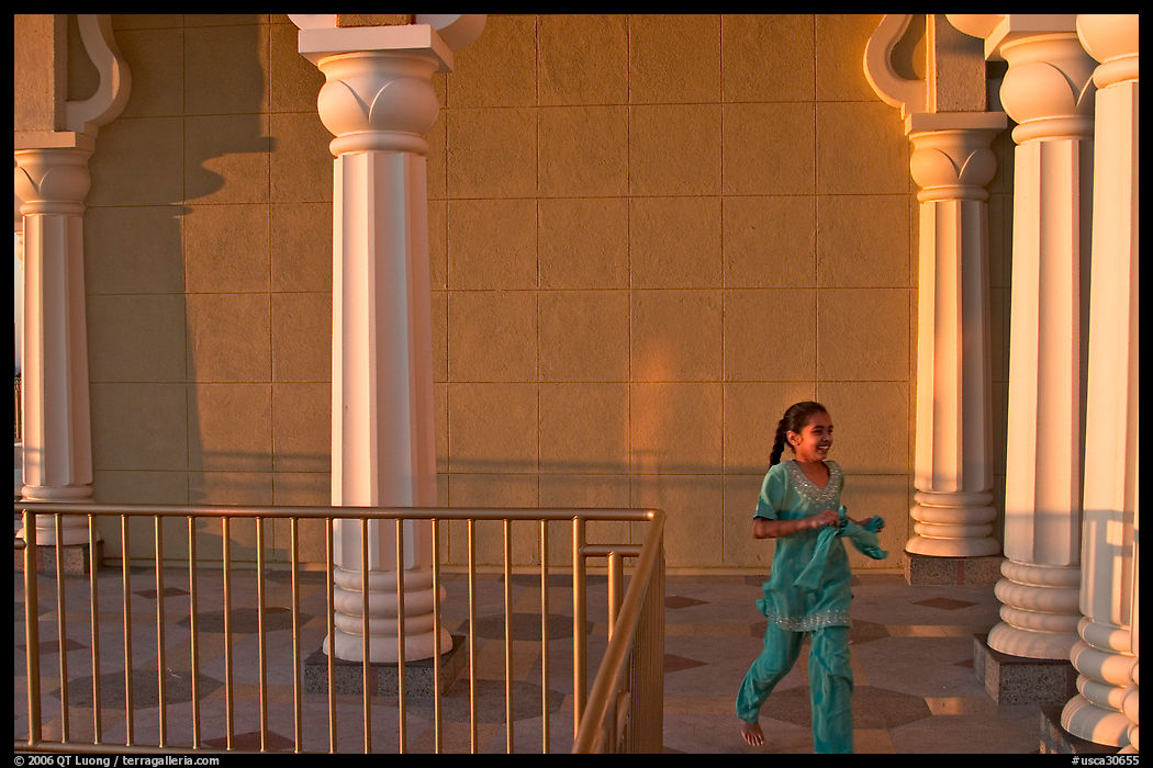 Indian girl running in the Sikh Gurdwara Temple, late afternoon. San Jose, California, USA