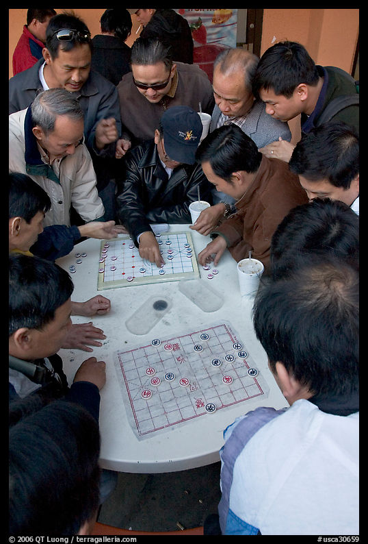 Vietnamese immigrants playing Chinese chess in a patio. San Jose, California, USA