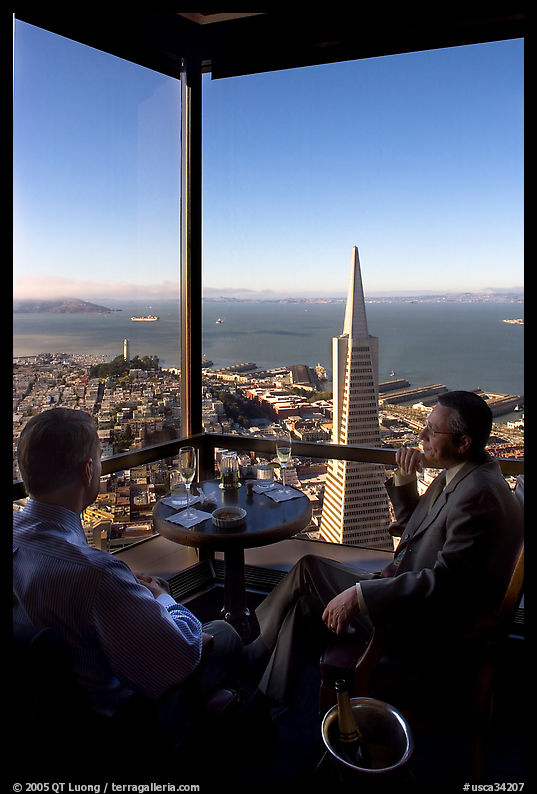 Businessmen with a bottle of Champagne in the Carnelian Room with panoramic view of the City. San Francisco, California, USA