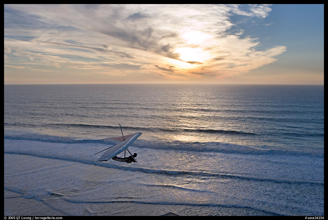 Hang glider flying  above ocean, Fort Funston, sunset. San Francisco, California, USA