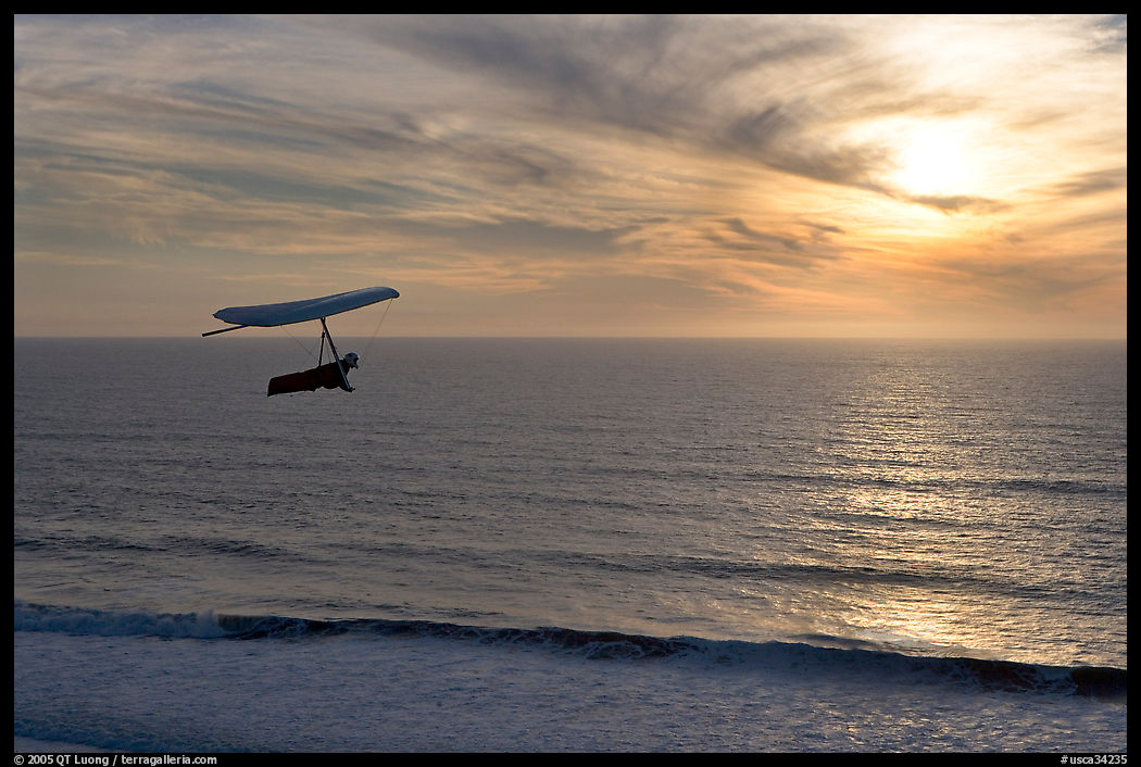 Hang gliding above the ocean at sunset,  Fort Funston. San Francisco, California, USA