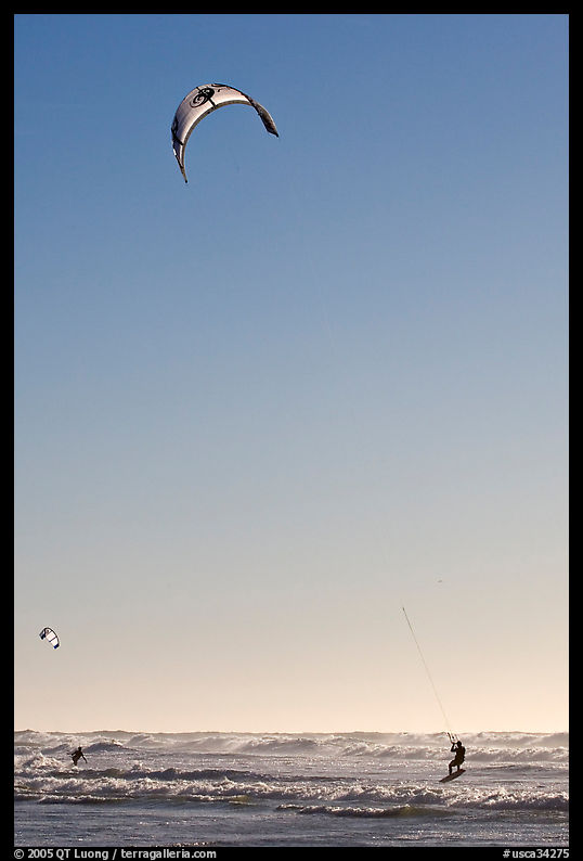 Kite surfing in Pacific Ocean waves, late afternoon. San Francisco, California, USA