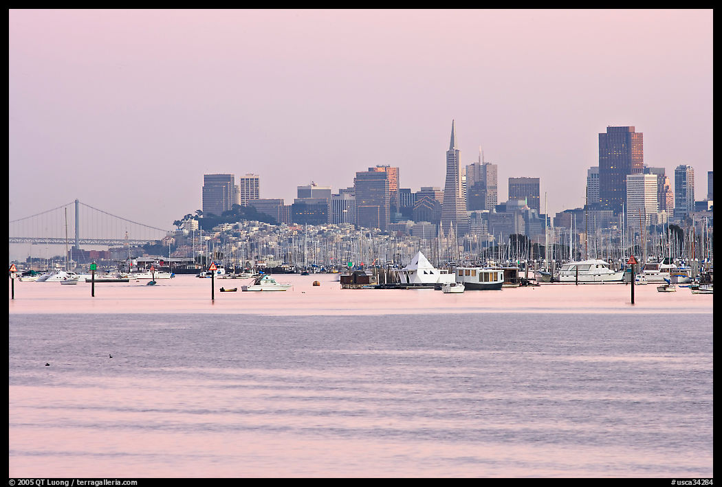 Alcatraz Island and Bay Bridge, painted in pink hues at sunset. San Francisco, California, USA