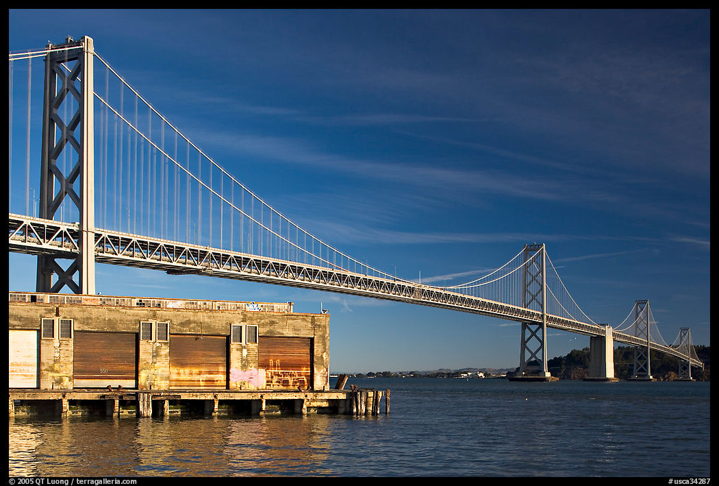 Old pier and Bay Bridge, early morning. San Francisco, California, USA