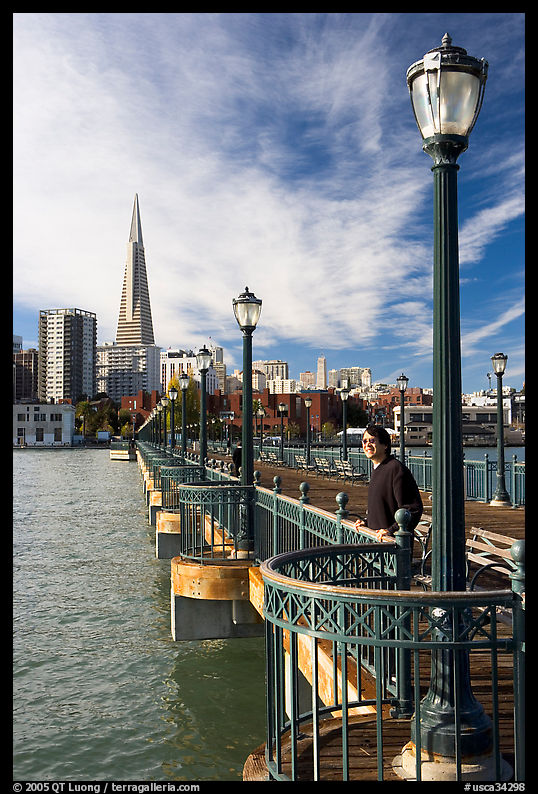 Visitor standing on pier 7, morning. San Francisco, California, USA