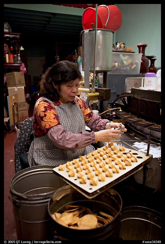 Woman folding fortune cookies, Chinatown. San Francisco, California, USA