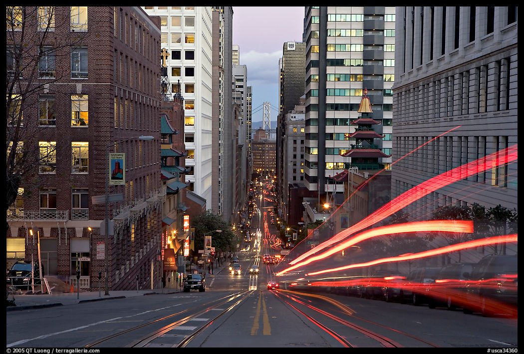 Cable-car rails,  Chinatown, Financial district, and Bay Bridge seen on California street. San Francisco, California, USA