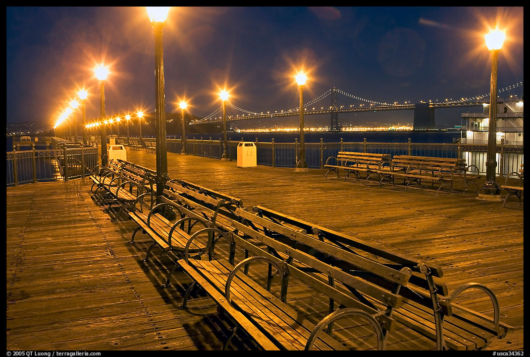 Benches and lights on Pier 7 with Bay Bridge in background, evening. San Francisco, California, USA