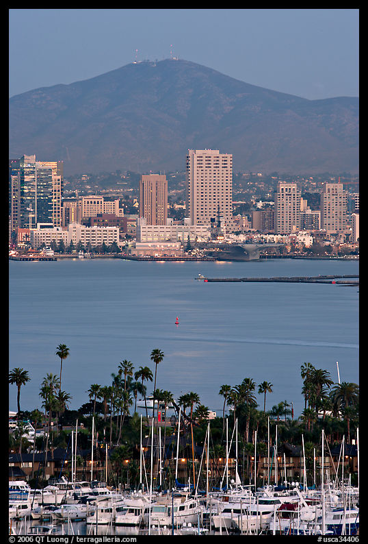 Yachts, skyline, and San Miguel Mountain, dusk. San Diego, California, USA