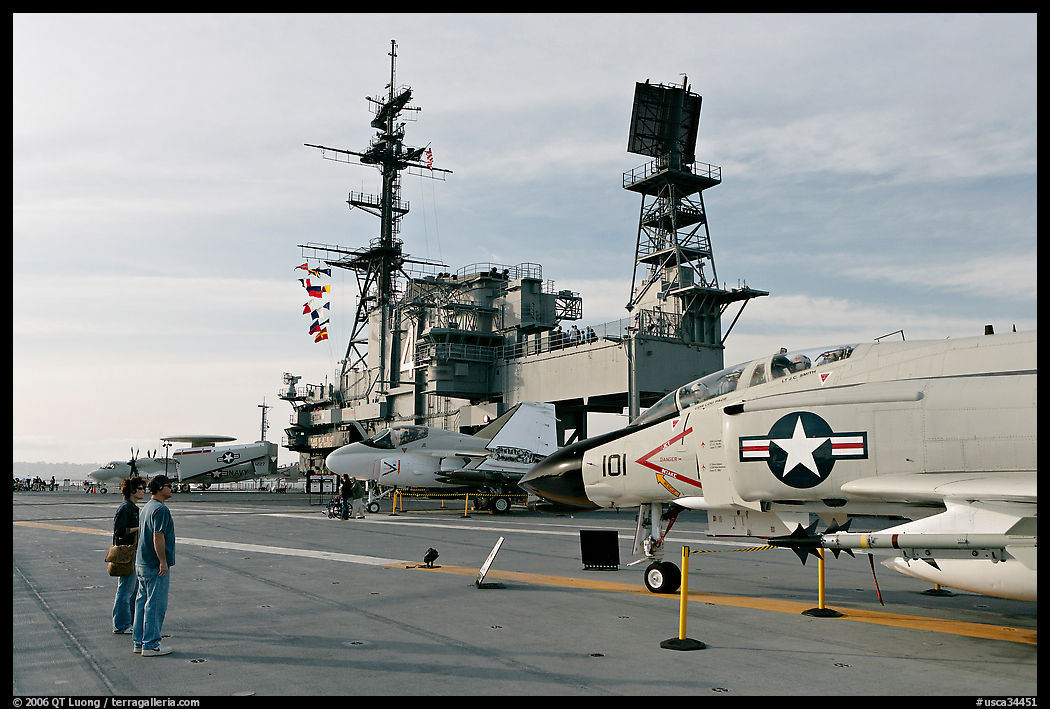 Couple looking at fighter aircraft on the Flight deck of USS Midway. San Diego, California, USA