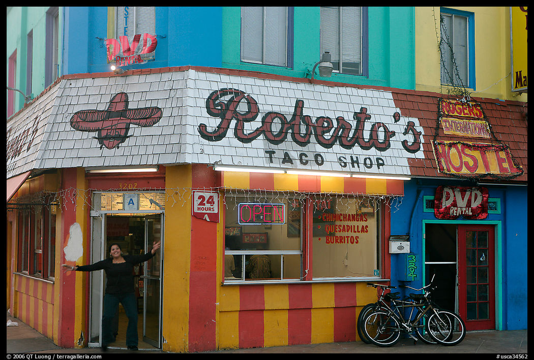 Woman exiting taco shop, Pacific Beach. San Diego, California, USA