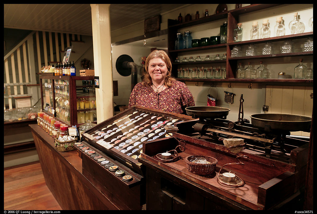 Woman standing behind counter of apothicary store, Old Town. San Diego, California, USA