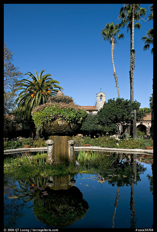 Palm trees reflected in central  courtyard basin. San Juan Capistrano, Orange County, California, USA