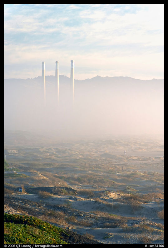 Chimneys of power plant emerging from the fog. Morro Bay, USA