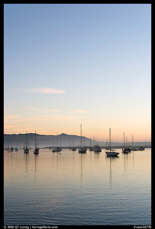 Yachts reflected in Morro Bay harbor, sunset. Morro Bay, USA