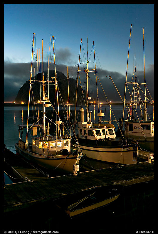 Lighted fishing boats and Morro Rock. Morro Bay, USA