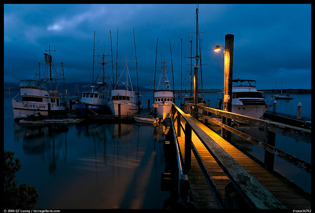 Deck and boats at night. Morro Bay, USA
