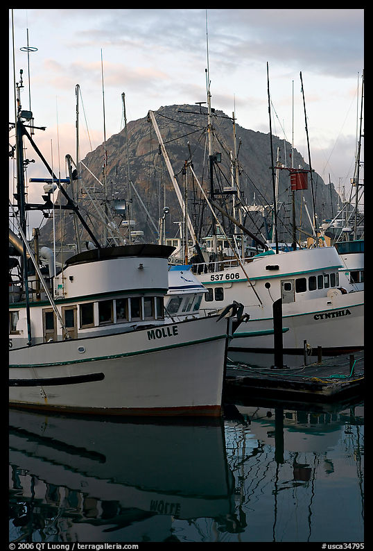 Fishing boats and Morro Rock, sunrise. Morro Bay, USA