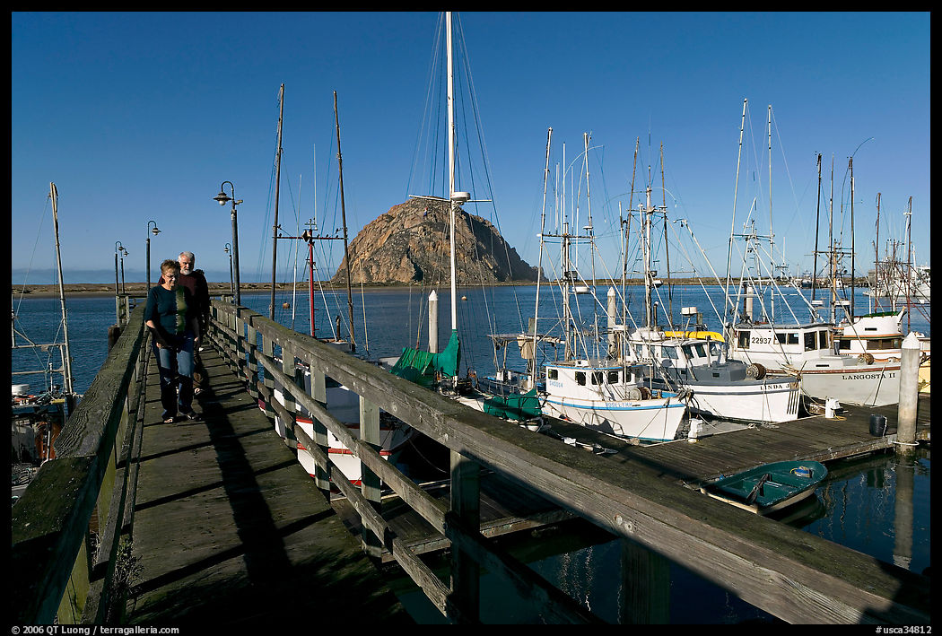 People walking on a deck in the harbor. Morro Bay, USA