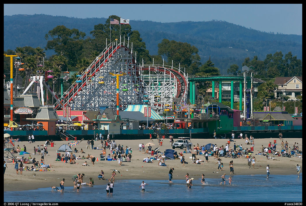 Beachgoers, and Santa Cruz boardwalk roller-coaster. Santa Cruz, California, USA
