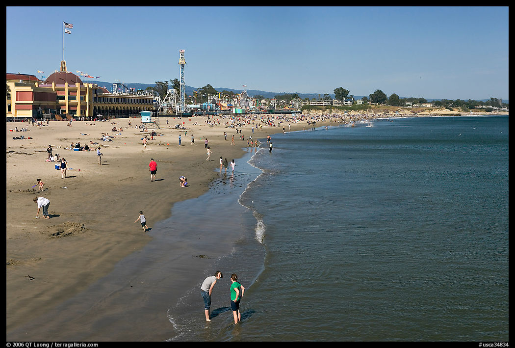 Beach with couple standing in water. Santa Cruz, California, USA