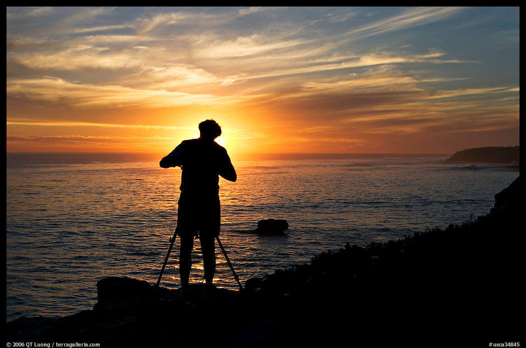 Photographer on cliffs at sunset. Santa Cruz, California, USA