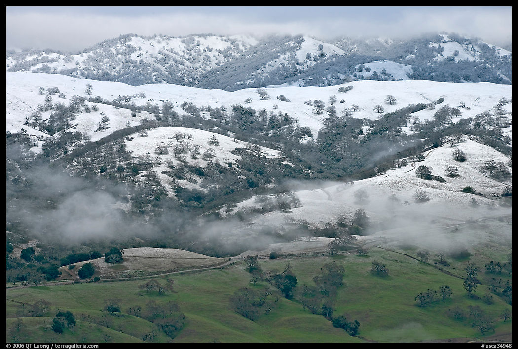 Snow on top of green hills of Mount Hamilton Range. San Jose, California, USA