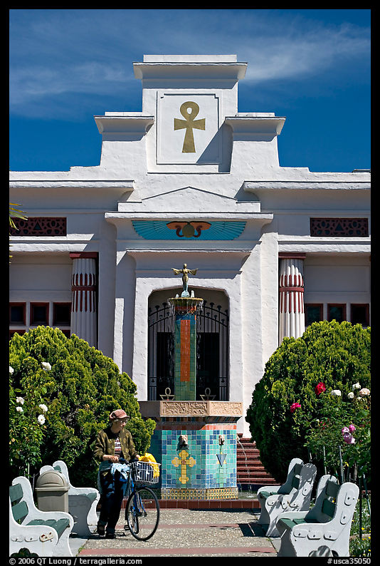 Visitor walking a bike, Rosicrucian Park. San Jose, California, USA