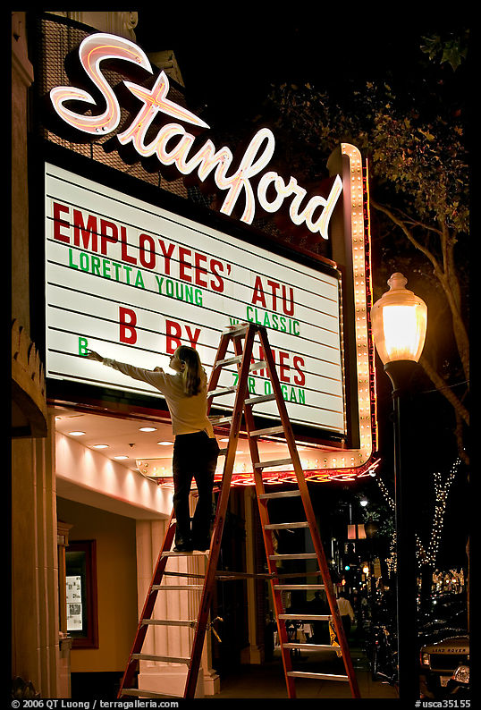Woman changing movie title, Stanford Theatre. Palo Alto, SF Bay area, California, USA