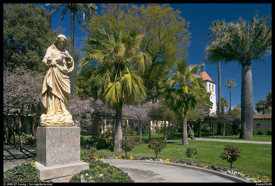 Statue, palm trees, and mission, Santa Clara University, Santa Clara. SF Bay area, California, USA