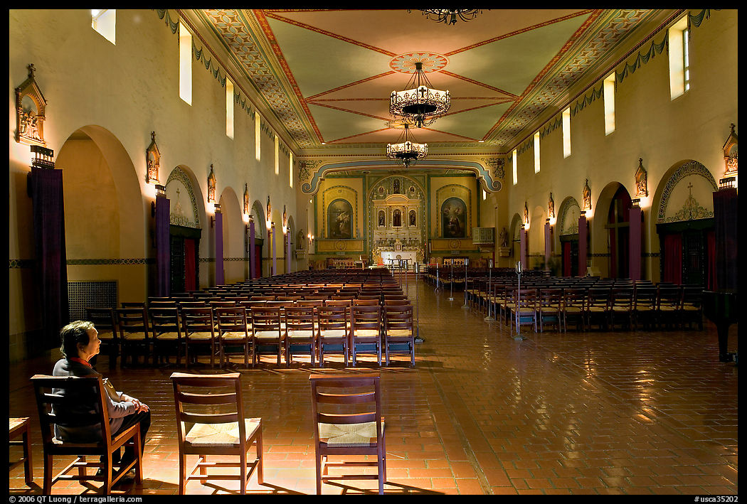 Woman sitting in chapel, Mission Santa Clara de Asis, Santa Clara. SF Bay area, California, USA