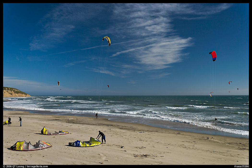 Kitesurfers rolling out sails on on beach, Waddell Creek Beach. SF Bay area, California, USA