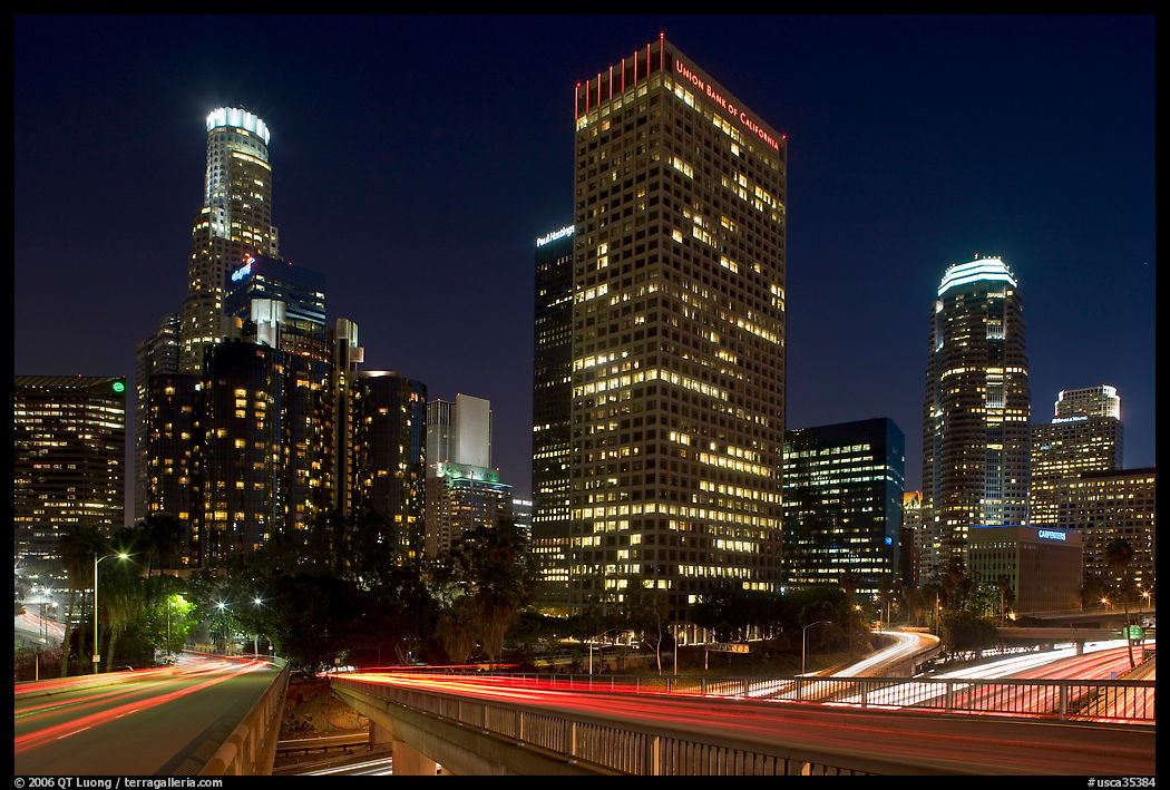 Bridge, traffic lights and Los Angeles skyline at night. Los Angeles, California, USA