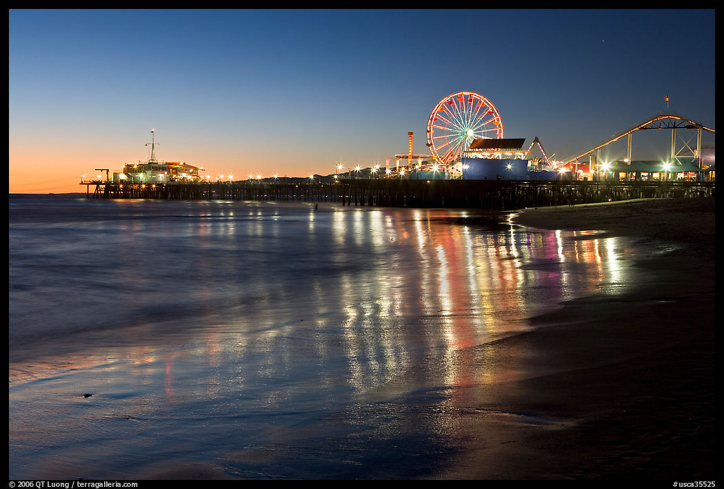 Pier and Ferris Wheel reflected on beach at dusk. Santa Monica, Los Angeles, California, USA